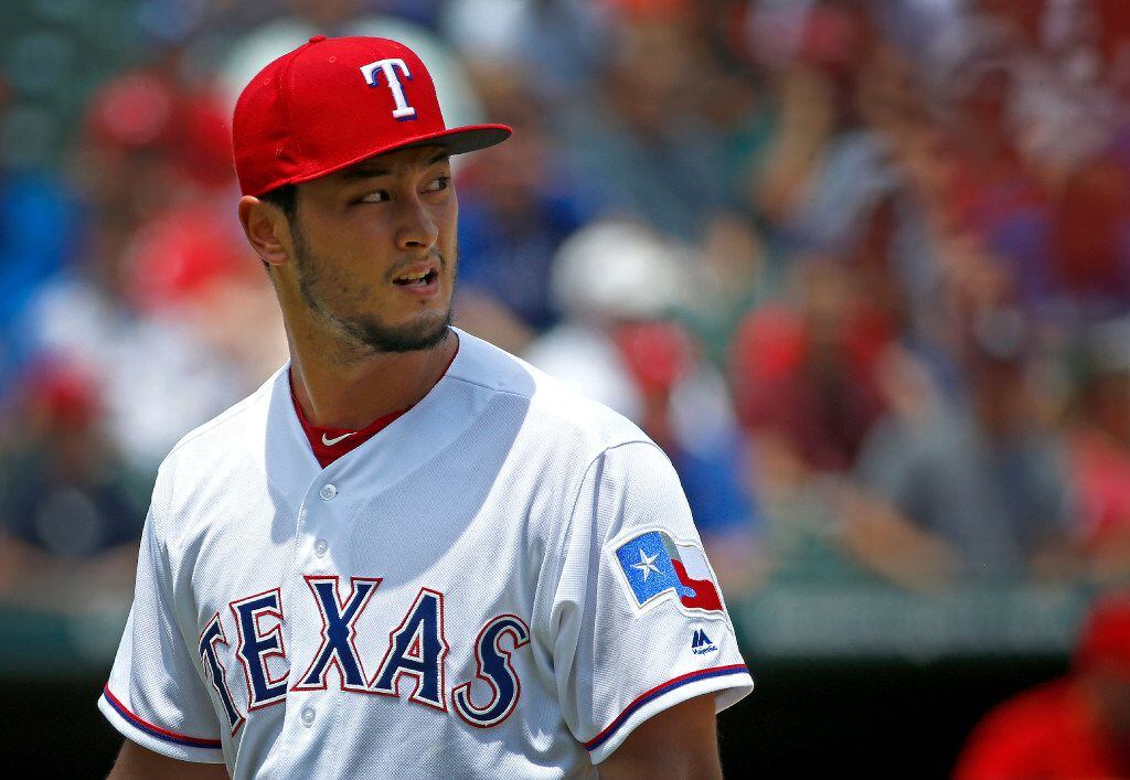 Texas Rangers starting pitcher Yu Darvish (11) walks back to the dugout during the second...