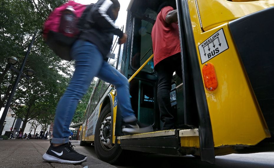 People board a DART bus at West Transfer Center in Dallas. 