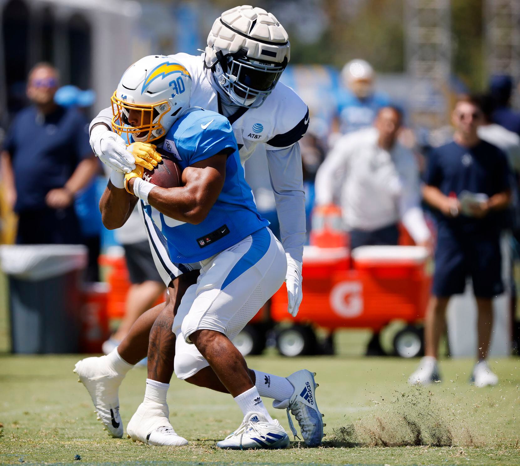 Dallas Cowboys linebacker Micah Parsons (11) gets his arm around Los Angeles Chargers...