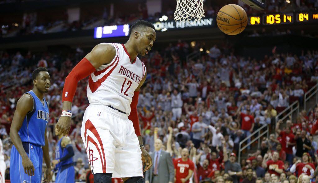 Houston Rockets center Dwight Howard (12) head buts the ball after a dunk during the second...