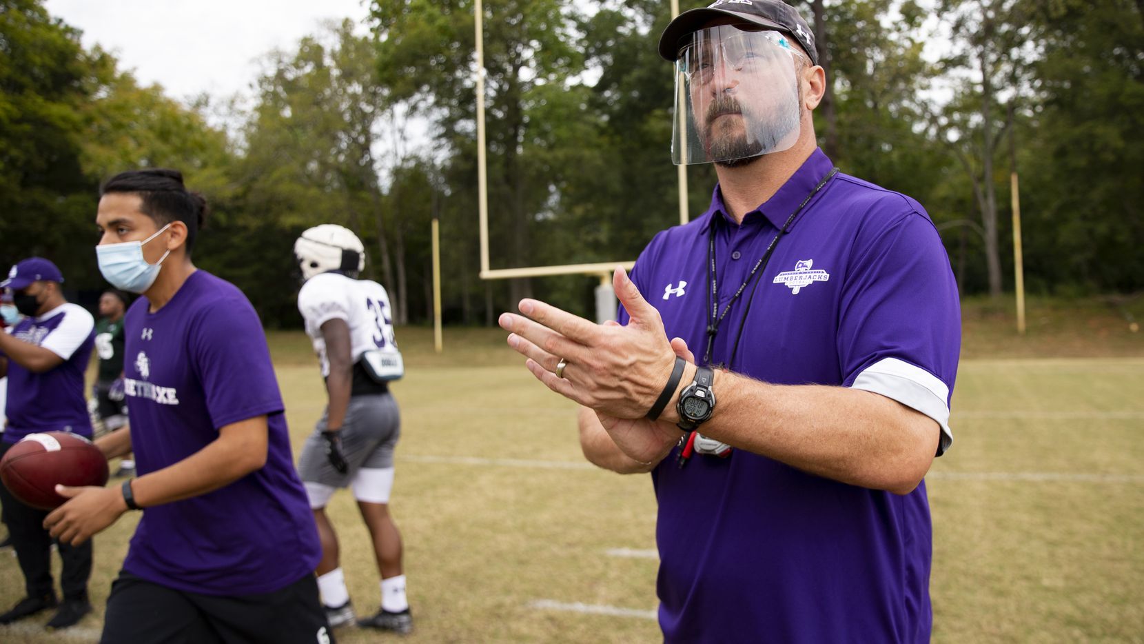 Stephen F. Austin Lumberjacks coach Colby Carthel wears a face shield during practice in...