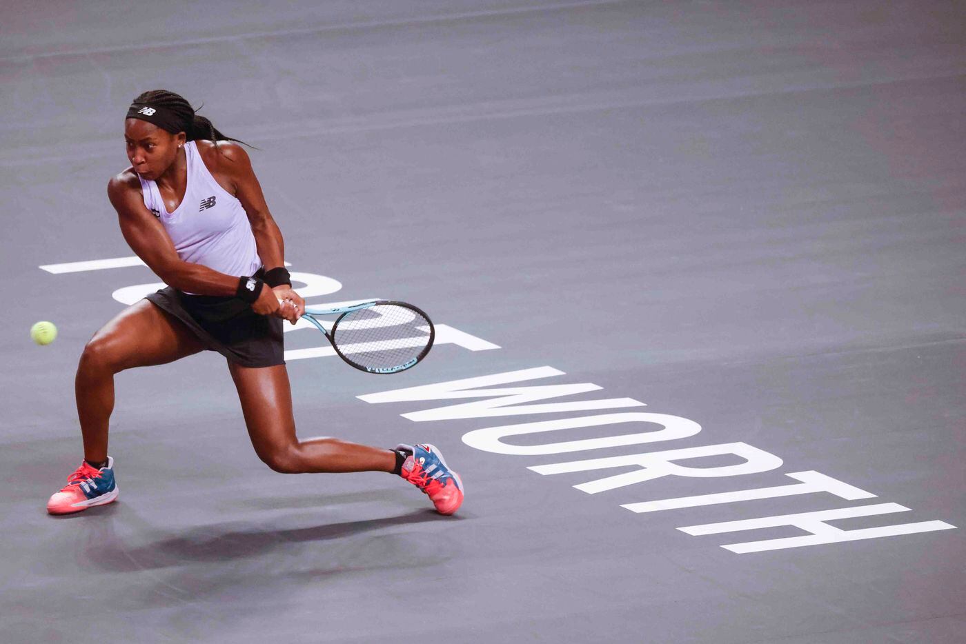 Coco Gauff of the USA plays a backhand shot against Caroline Garcia of France on day two of...