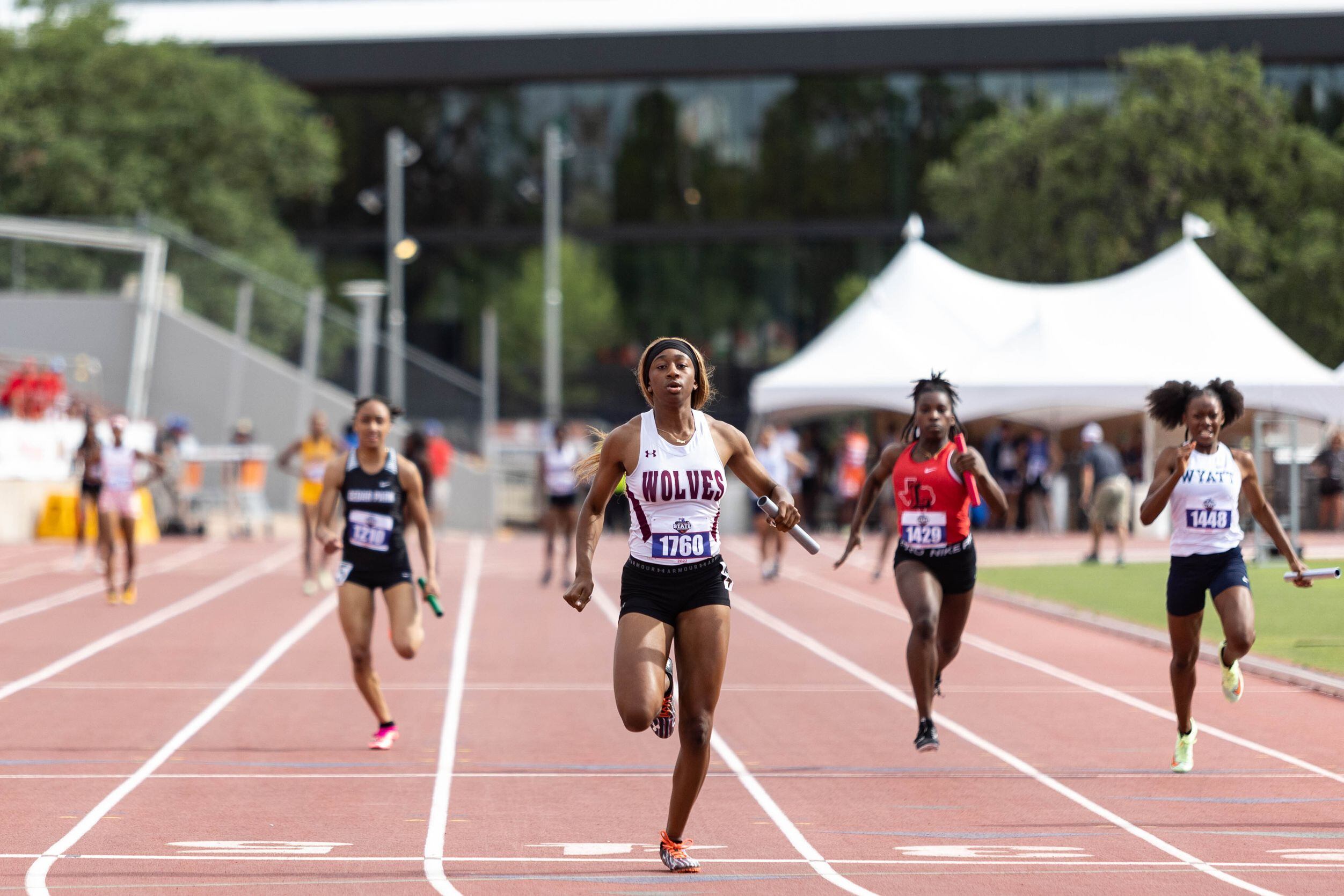 Lola Mabon, second from the left, anchors the girls’ 4x100 relay for Mansfield Timberview at...