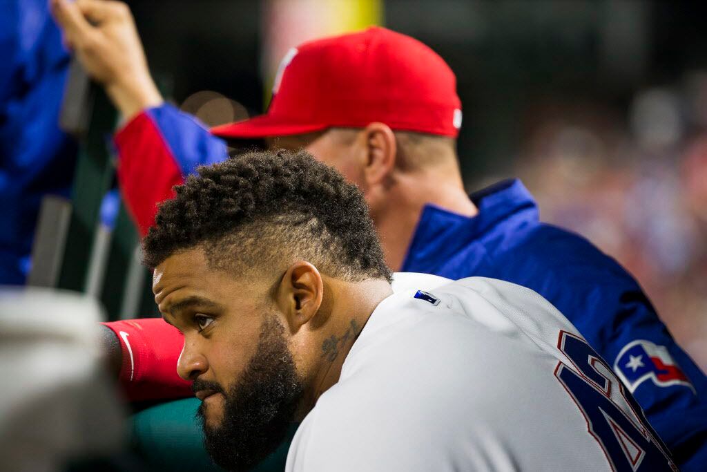 Texas Rangers designated hitter Prince Fielder watches from the dugout at the Rangers give...