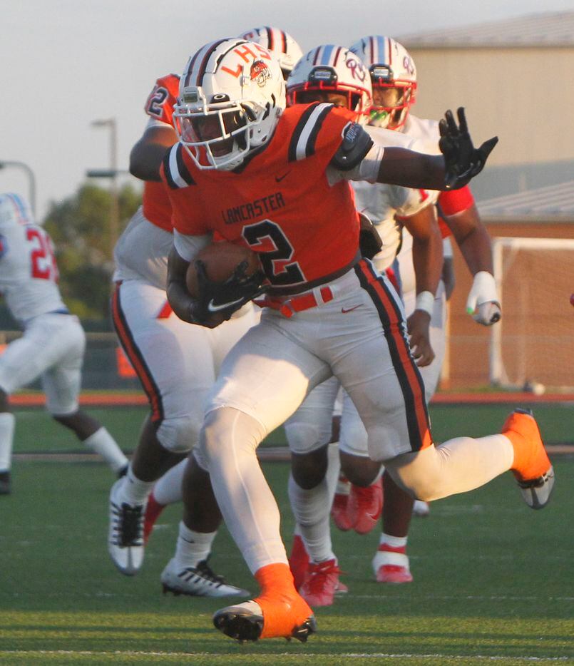 Lancaster running back Kewan Lacy (2) rambles into the Dallas Skyline secondary for a first...
