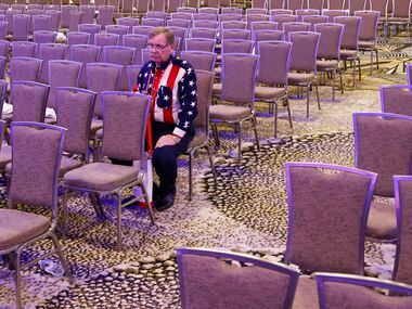 Attendee T.E Sumner wearing an attire of the U.S National flag sits by himself after the...