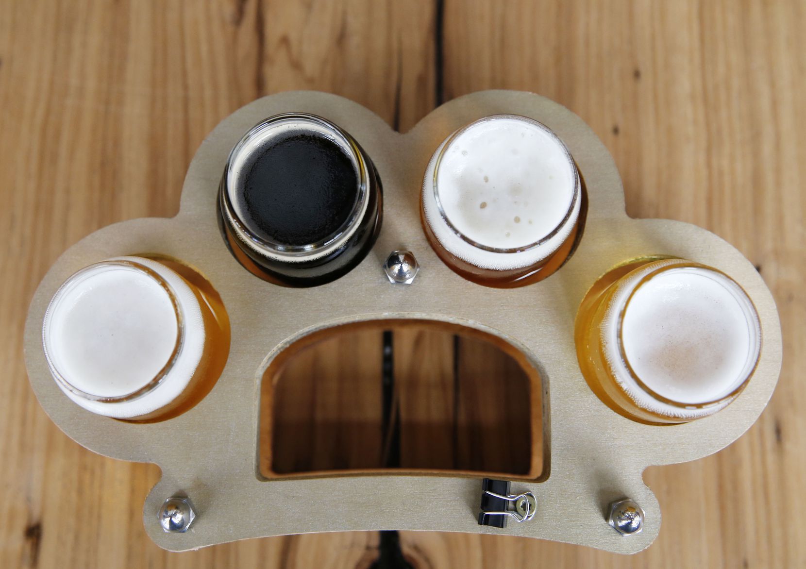 Flights of beer come served in a tray shaped like brass knuckles at Austin Beerworks. 