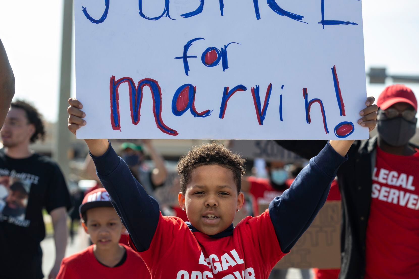 Elijah Lyons, 9, leads a march out of the Allen Outlets on Sunday, March 21, 2021 demanding...
