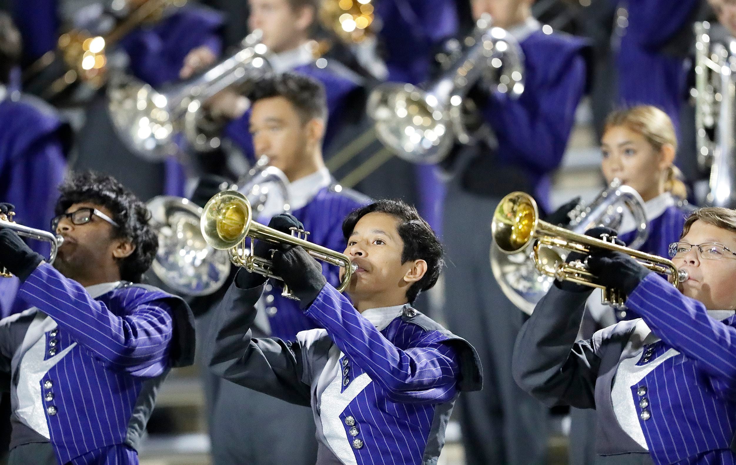 Manuel Cristales (center), 15,  plays the trumpet with the Lone Star High School marching...