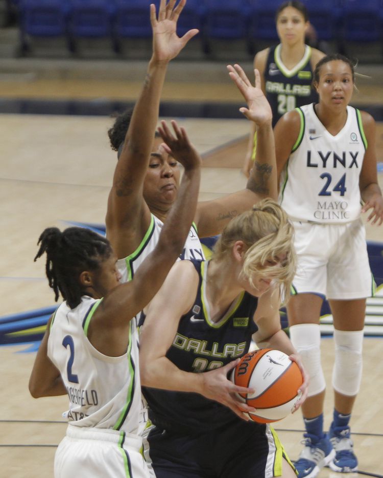 Dallas Wings center Bella Alarie (32) got a face full of her own hair as she drives under the basket against the defense of Minnesota Lynx guard Crystal Dangerfield (2) and Damiris Dantas (12) during 3rd quarter action. The two teams played their WNBA game at College Park Center on the campus of the University of Arlington on June 17, 2021(Steve Hamm/ Special Contributor)