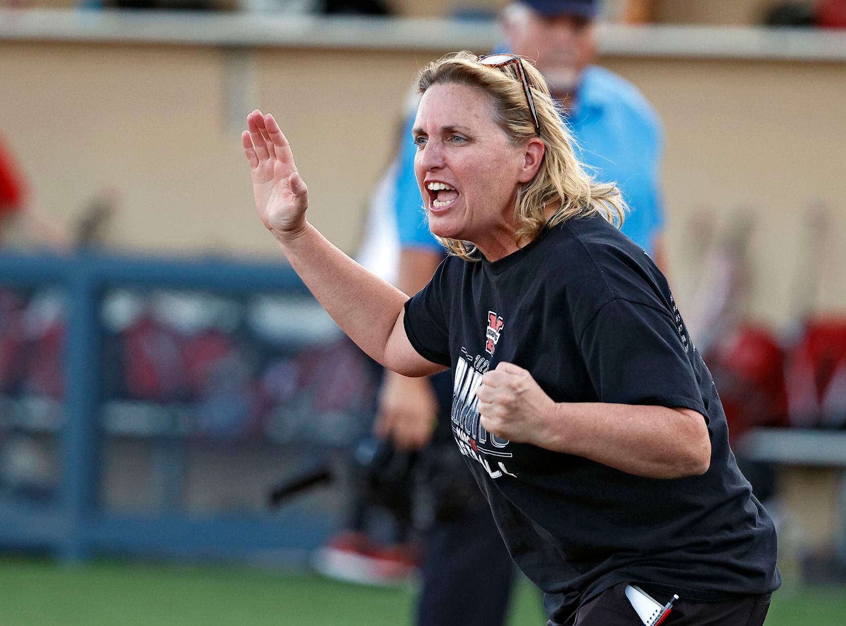 Flower Mound Marcus coach Christy Tumilty cheers as Alexa Hanish (7) hit a home run during...