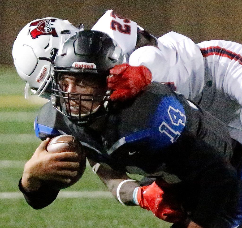 Plano West High School quarterback Andrew Picco (14) is face masked by McKinney Boyd High...