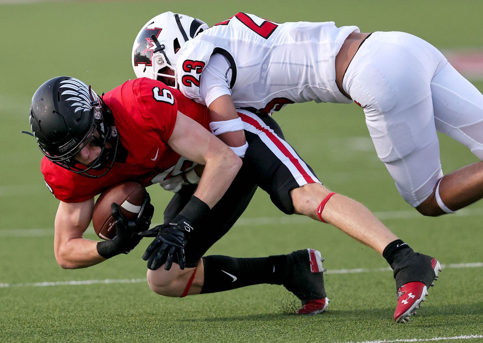 Argyle's Lane Stewart (6) is stopped for a short gain by Melissa's Josh Nicholas (23) during...