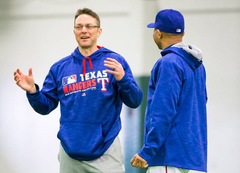 Texas Rangers hitting coach Anthony Iapoce (left) chats with third base coach Tony Beasley...