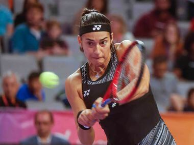 Caroline Garcia of France returns a backhand shot against Coco Gauff of the USA on day two...