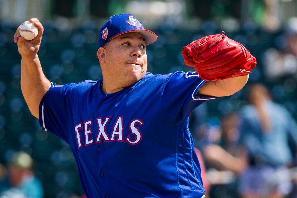 Texas Rangers pitcher Bartolo Colon pitches during the first inning of a spring training...