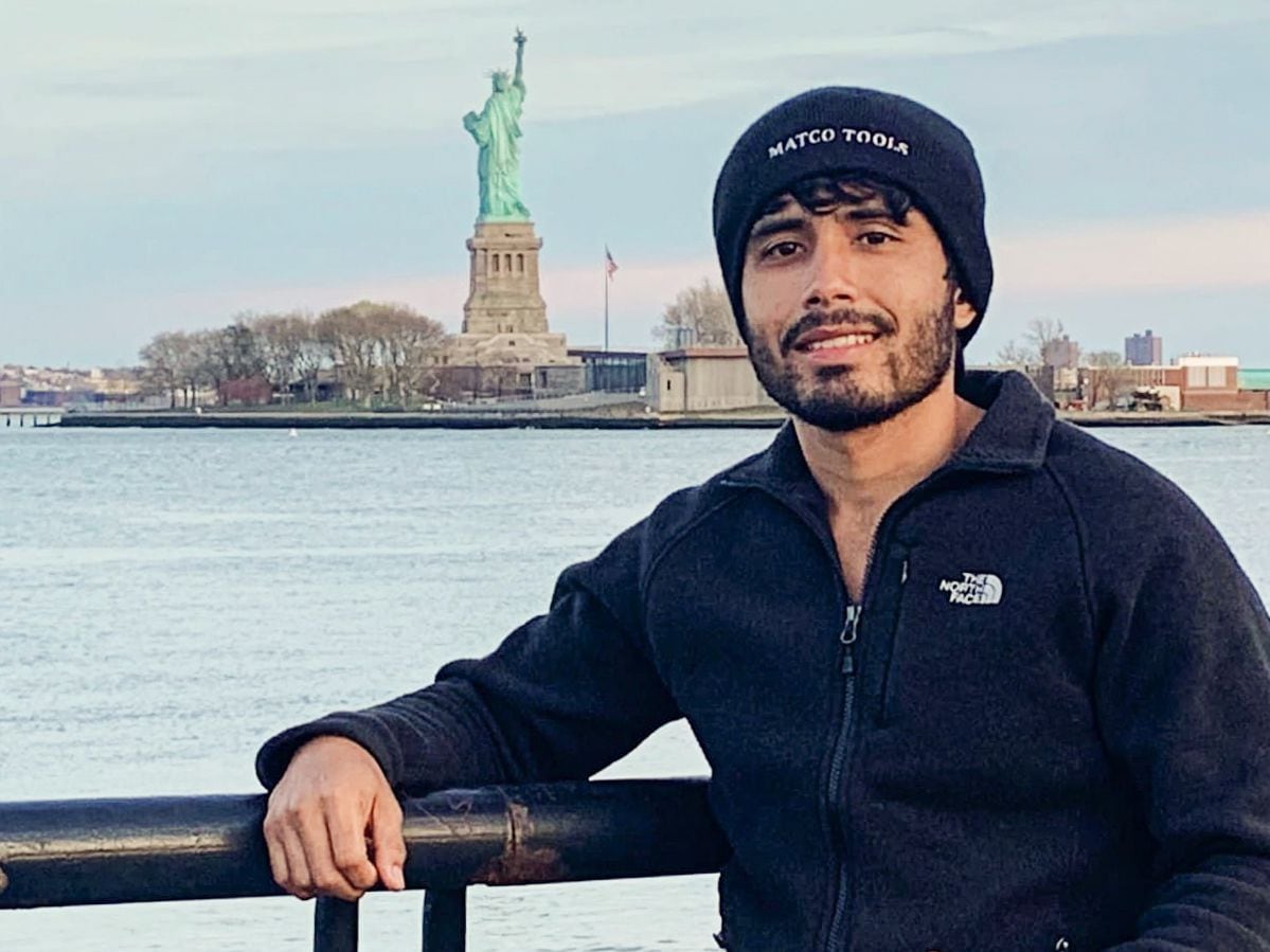 Víctor Rodríguez posed for a photo with the Statue of Liberty in New York on April 22, 2022....