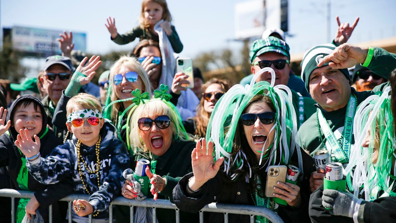 People cheer at Dallas’ annual St. Patrick’s Day parade on Saturday.