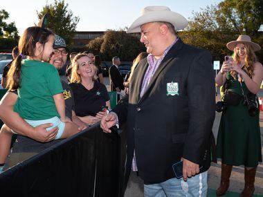 Dallas Stars owner Tom Gaglardi greets fans Rosalyn Dinh, 6, and her father Toan Dinh, as he...