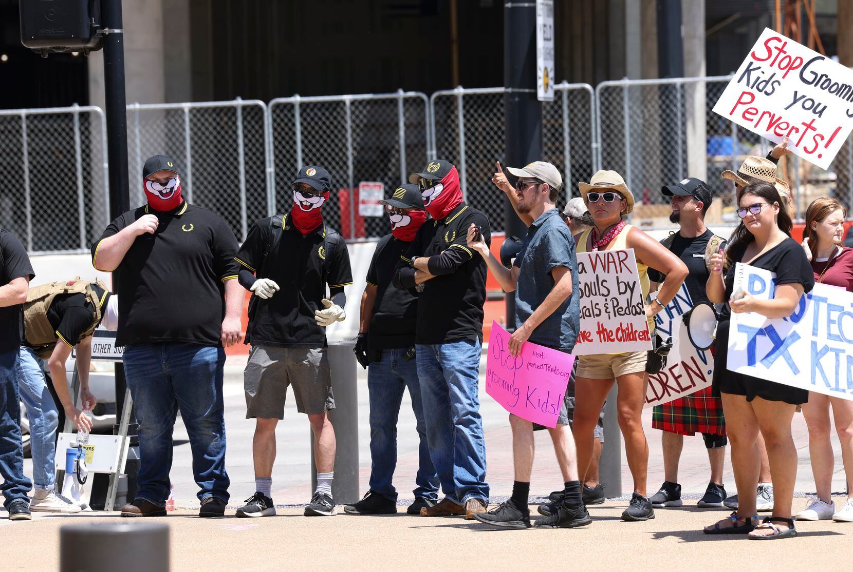 Members of far-right extremist group the Proud Boys (far left) attend a protest with Protect...