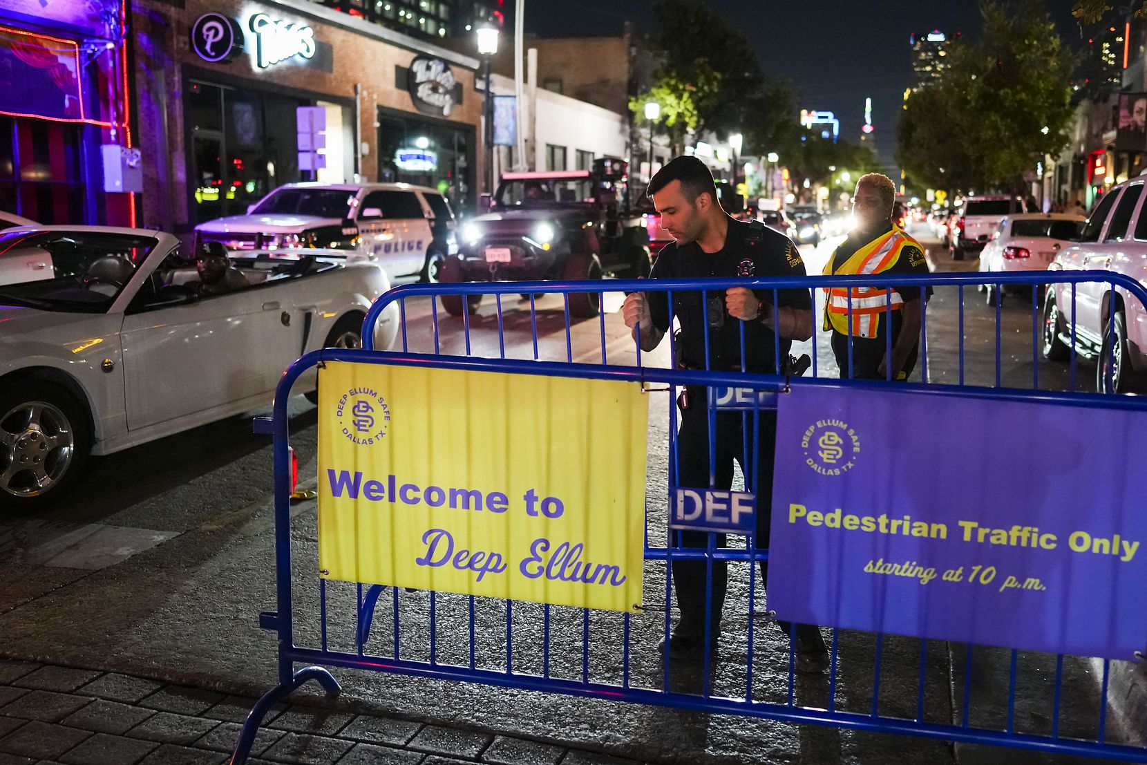 Dallas police set out barricades to close the intersection of Main Street at Malcolm X in...