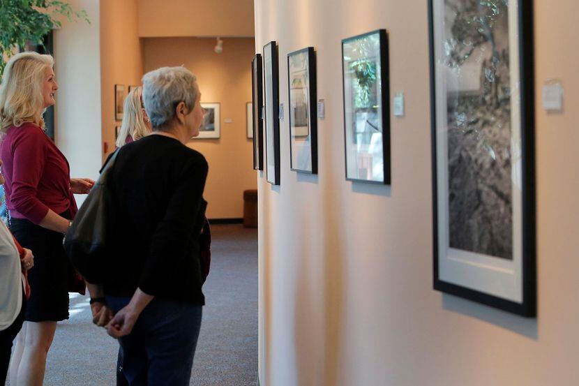 A group of visitors from the Campbell Green Recreation Center look through a gallery of...