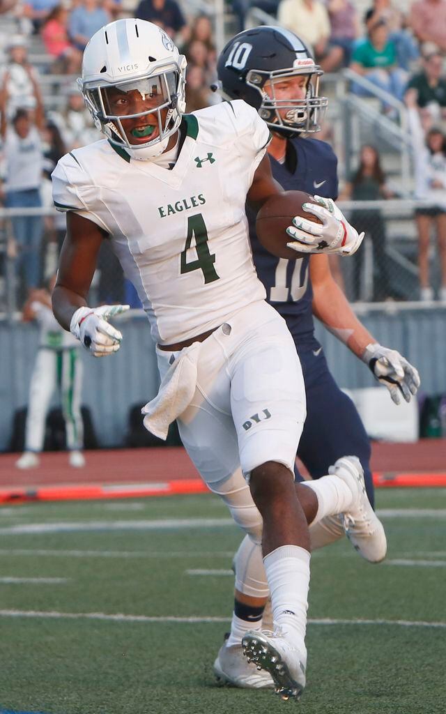 Prosper receiver Tyler Bailey (4) crosses into the end zone past Flower Mound's Josh...