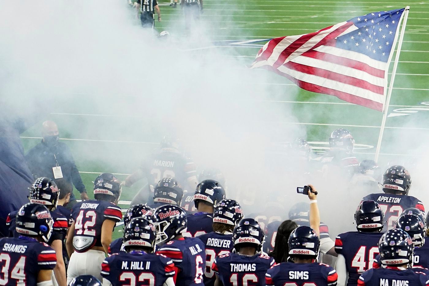 Denton Ryan players take the field to face Cedar Park in the Class 5A Division I state...