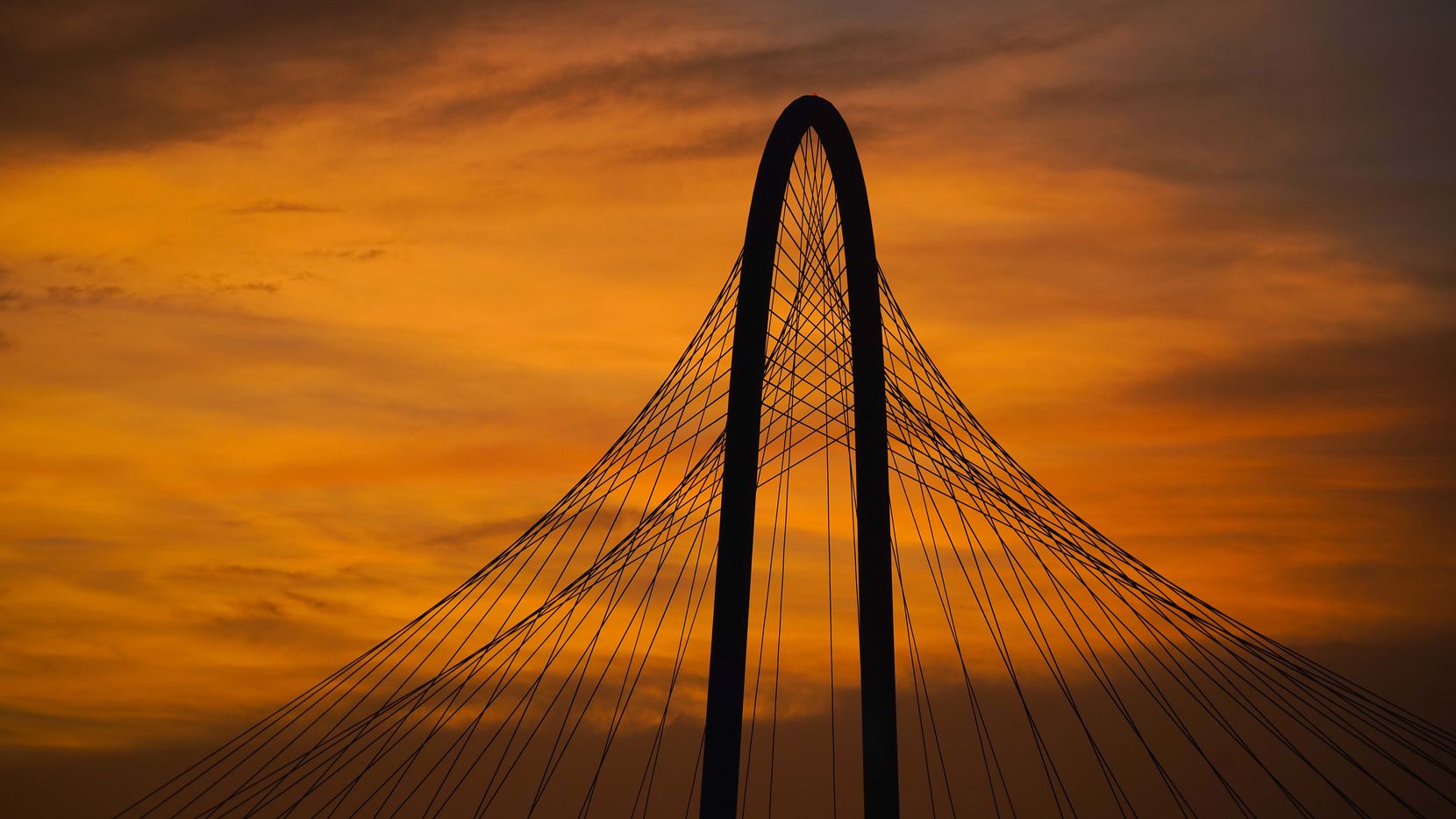 The lingering colors of sunset silhouette the Margaret Hunt Hill Bridge on Tuesday, June 30, 2020, in Dallas.