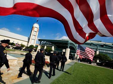 Police officers arrive to Prestonwood Baptist Church in Plano for the funeral service of...