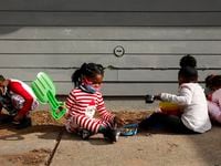 Children play outside at Child Care Group's Landauer Center in Dallas on Dec. 16, 2021.