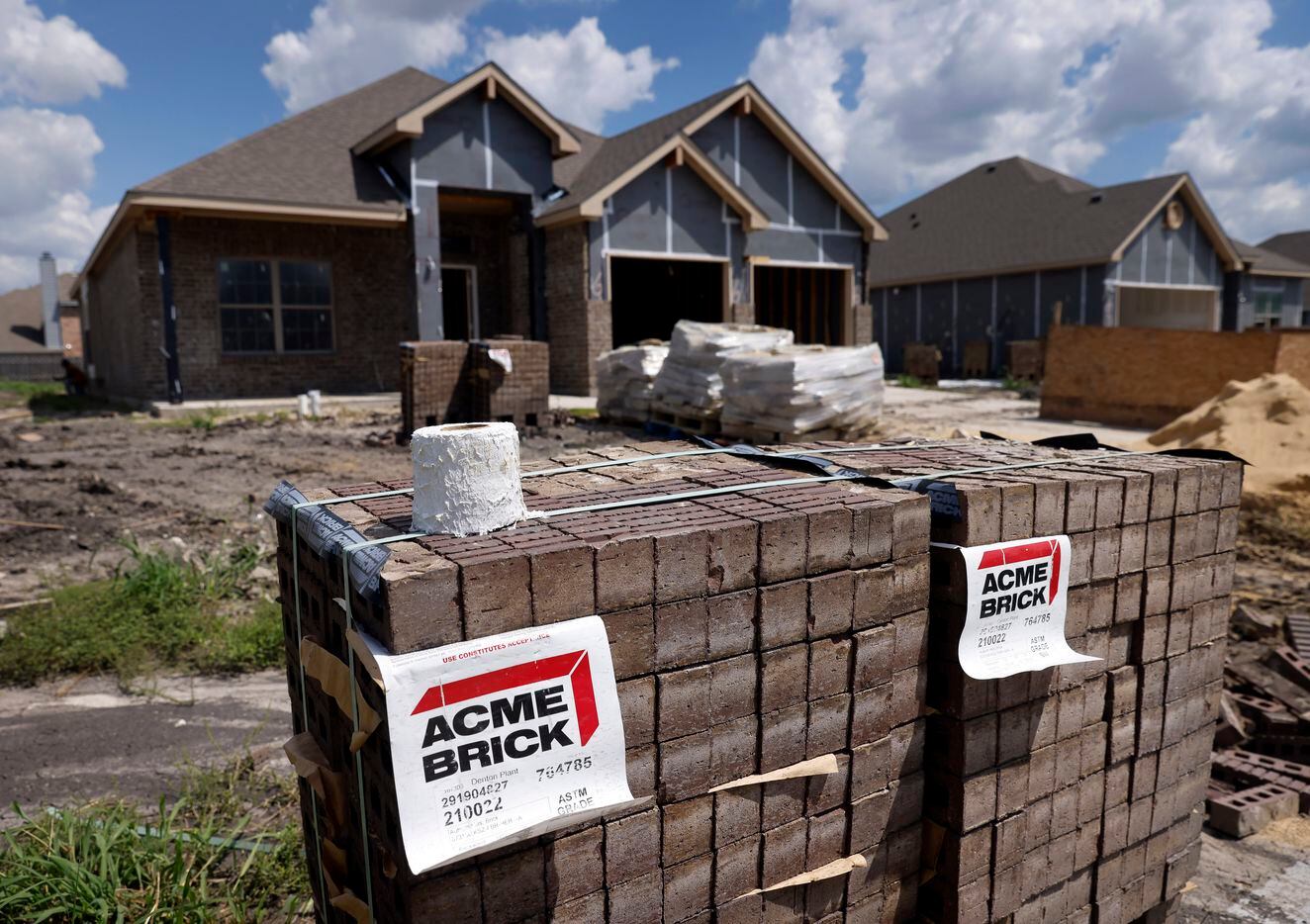 Acme Bricks are stacked outside an Altura single family home under construction in the River...