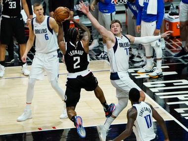 LA Clippers forward Kawhi Leonard (2) scores past Dallas Mavericks guard Luka Doncic (77) during the final minute of fourth quarter of an NBA playoff basketball game at the Staples Center on Wednesday, June 2, 2021, in Los Angeles. The Mavericks won the game 105-100.