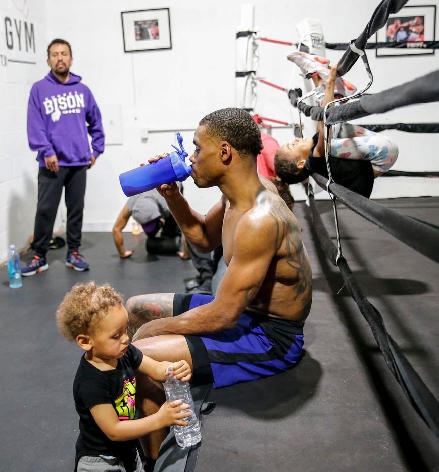 Errol Spence Jr. of Desoto, cools off as her daughter Ivy, back, plays with the ropes and...