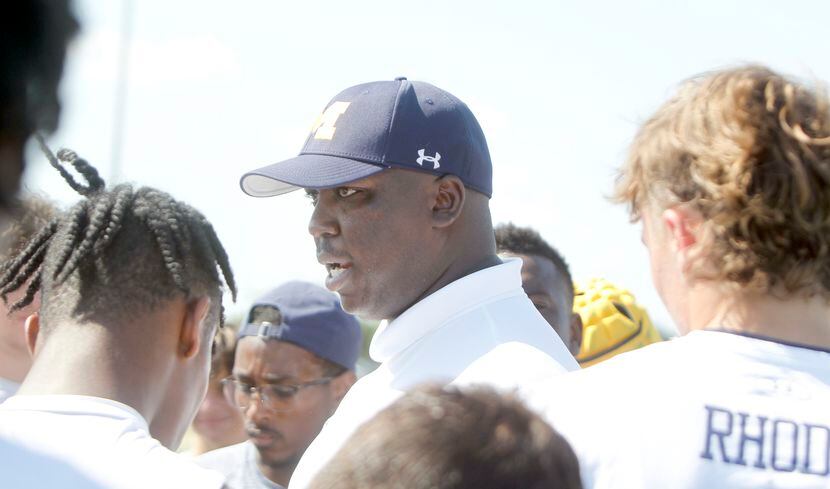 McKinney head football coach Marcus Shavers spoke with his players after their...