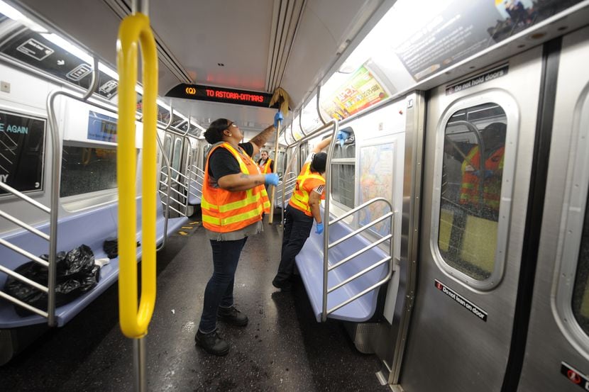 MTA personnel clean a subway car in Brooklyn, New York on Tuesday.