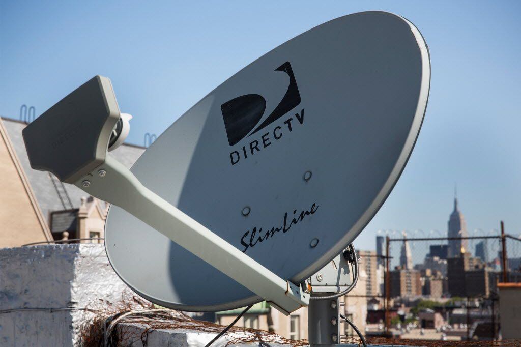 A DirecTV sattelite dish sits on a roof on May 19, 2014 in New York City. AT&T agreed May...