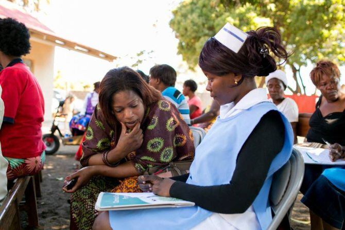 In Livingstone, Zambia, Eliza Tufule meets with a nurse at the Mosi-Oa-Tunya Health Center...