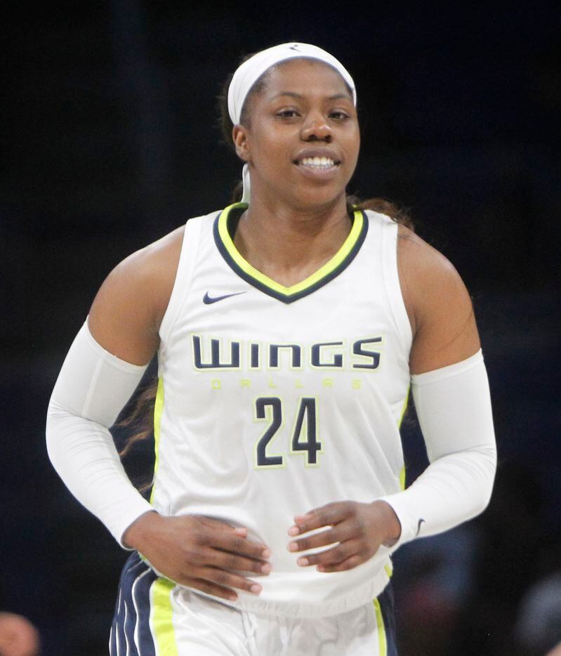 Dallas Wings guard beams after the first half announcement that she had become the 5th...