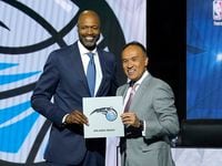 Orlando Magic head coach Jamahl Mosley, left, stands with NBA Deputy Commissioner Mark Tatum...