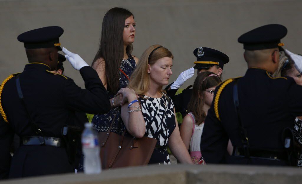 Family members of fallen officers are escorted in during a candlelight vigil hosted by the Dallas Police Association at Dallas City hall in Dallas, TX July 11, 2016. (Nathan Hunsinger/The Dallas Morning News)