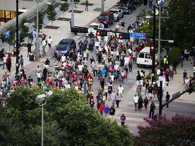 Demonstrators in Black Lives Matter march pass through the intersection of Main and Griffin...