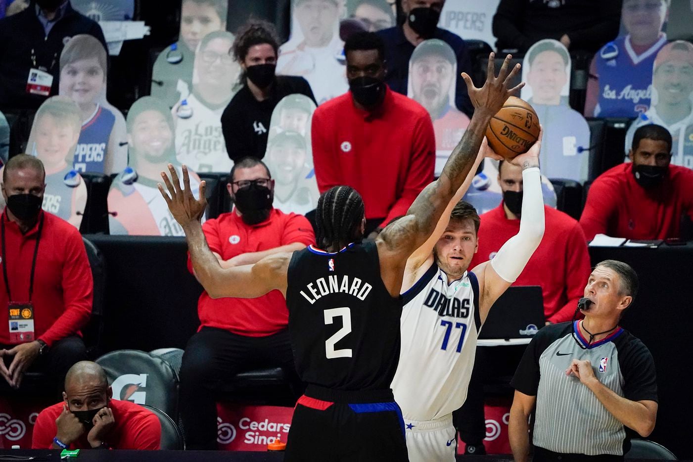 Dallas Mavericks guard Luka Doncic (77) inbounds the ball past LA Clippers forward Kawhi Leonard (2) during the second half of an NBA playoff basketball game at Staples Center on Wednesday, May 26, 2021, in Los Angeles. The Mavericks won the game 127-121.
