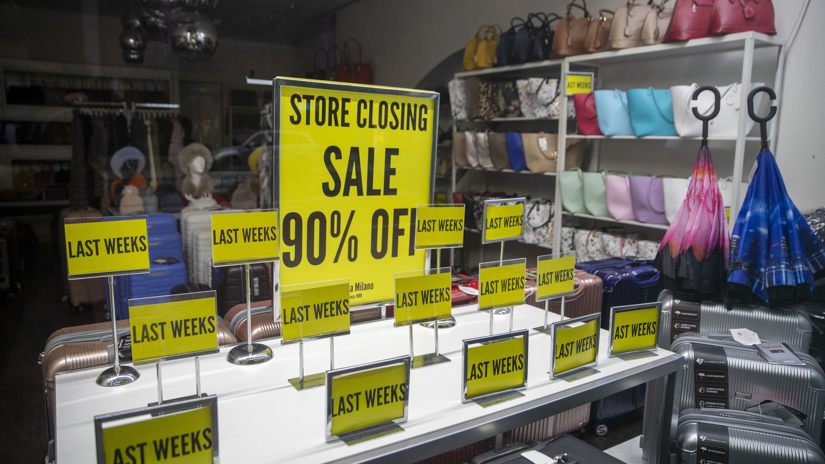 "Store Closing" sale signs on display at a shop on Madison Avenue in New York.