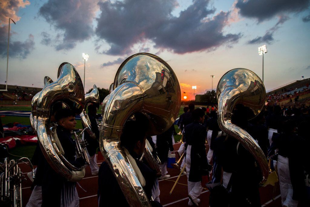 Duncanville band members make their way to the stands before a high school football game...