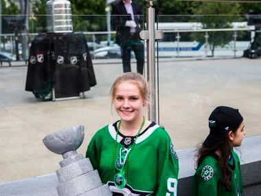 Megan Filippo holds a model that she made of the Stanley Cup while posing for a photo with...