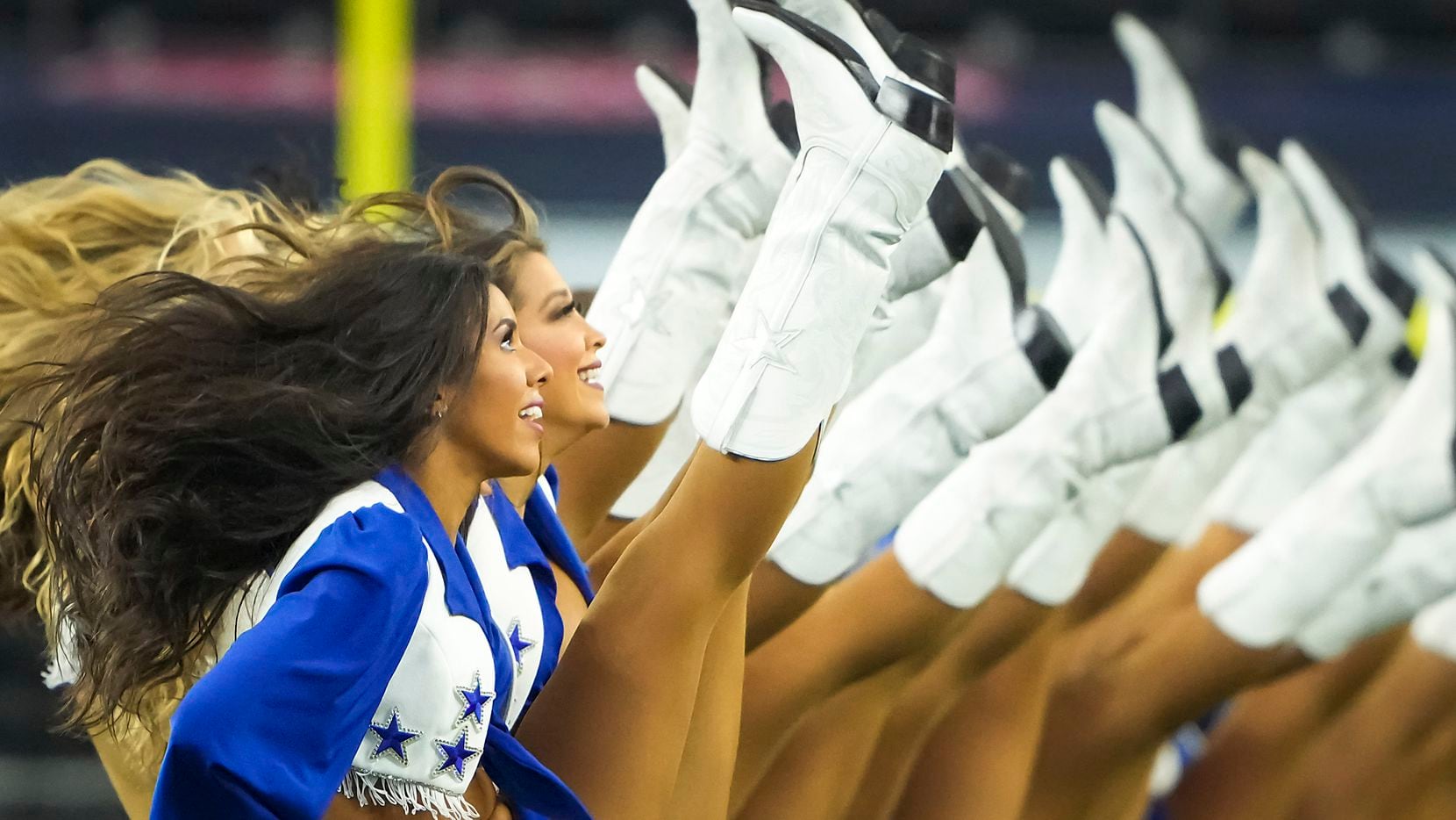 The Dallas Cowboys Cheerleaders perform before a preseason NFL football game against the Houston Texans at AT&T Stadium on Saturday, Aug. 21, 2021, in Arlington.