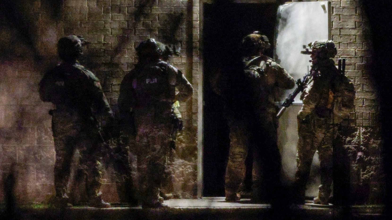 Members of the FBI exit a side entrance while conducting SWAT operations at Congregation...