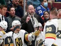 VANCOUVER, BC - APRIL 3: Head coach Peter DeBoer of the Vegas Golden Knights talks to Robin...