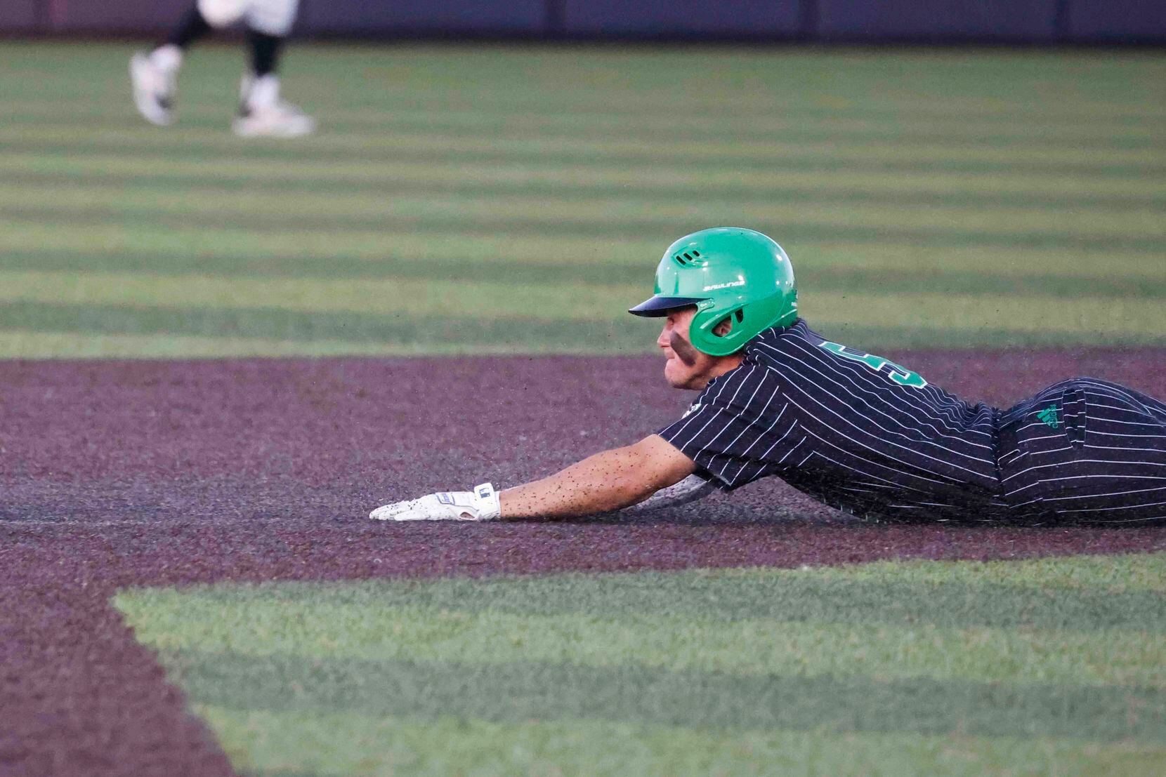 Southlake Carroll’s Brady Miller attempts to touch the fourth base during the first inning...